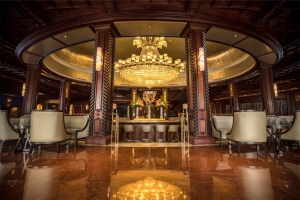 large, open bar space with a large chandelier overhead