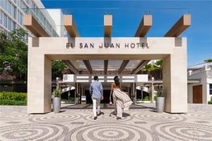 two people talking into el san juan hotel